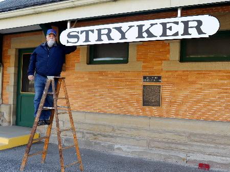 Stryker depot front with Bruce Zigler next to Stryker sign Dec 2020